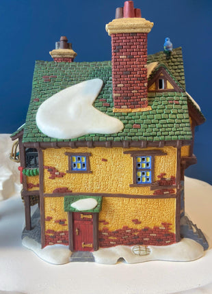 Illuminated Porcelain Christmas Village "Wingham Lane Parrot Seller" House" by Dept 56. and Woman Holding Bird Cage, Dickens Village, 1999.