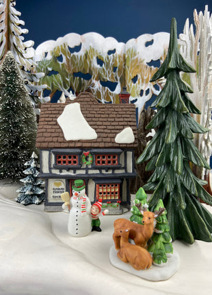 Illuminated Porcelain Christmas Village "Wingham Lane Parrot Seller" House" by Dept 56. and Woman Holding Bird Cage, Dickens Village, 1999.