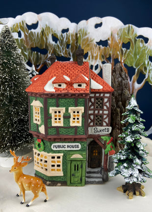 Illuminated Porcelain Christmas Village "Wingham Lane Parrot Seller" House" by Dept 56. and Woman Holding Bird Cage, Dickens Village, 1999.
