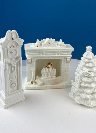 White Porcelain Figurines of Santa & His Family Celebrating Christmas in Front of Fireplace. Illuminated Fireplace and Tree. Mantel Display.