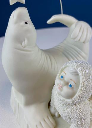 Snow Baby Imitating Seal Trying to Reach a Star. Snow Babies Figurine Celebrating Friendship. Department 56 Collectibles. Kids Room.