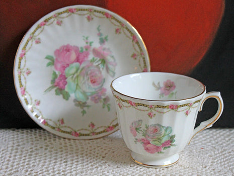 Antique Cup and Saucer with Roses Pattern by Duches , England.
