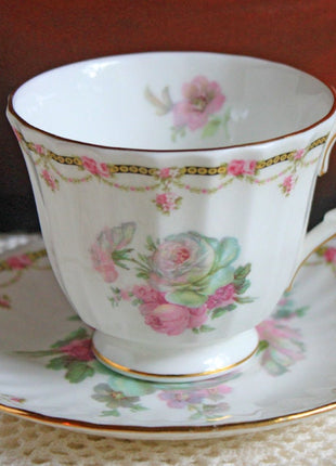 Antique Cup and Saucer with Roses Pattern by Duches , England.