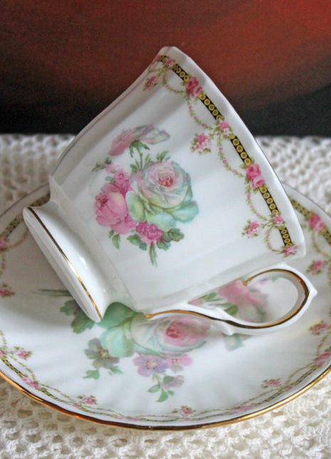 Antique Cup and Saucer with Roses Pattern by Duches , England.