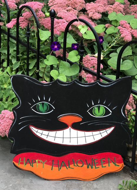 Sign on Wooden Black Cat Cutout Reading Happy Halloween.