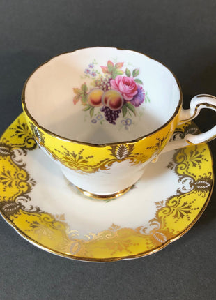 Antique Cup and Saucer by Paragon. White, Yellow, Gold, Pink. Made in England.