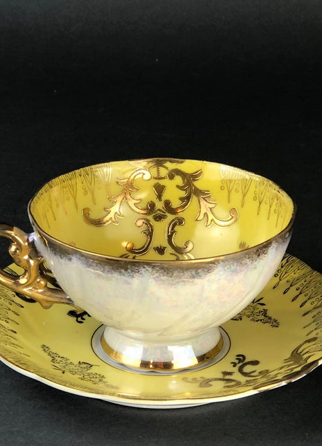 Antique Cup and Saucer Set by Royal Sealy China, Japan. Yellow Cup and Saucer with Rich Gold Decor and Iridescent Background Outside.
