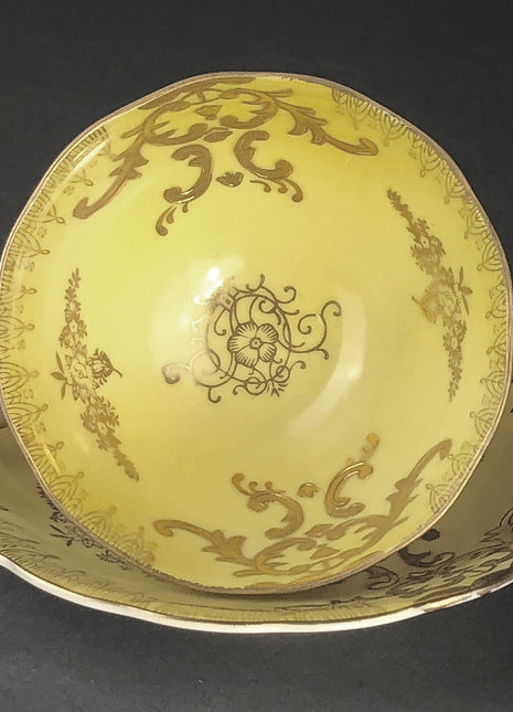Antique Cup and Saucer Set by Royal Sealy China, Japan. Yellow Cup and Saucer with Rich Gold Decor and Iridescent Background Outside.