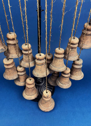 Collection of Hanging Bells.  Seventeen Rustic Clay Bells Suspended from Piece of Wood.  Wall Hanging.