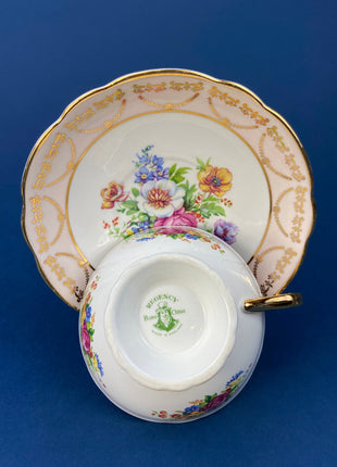 Regency Tea Cup and Saucer. Antique Hand-Painted Porcelain Cup and Saucer. Peach with Wild Flower Bouquet Motif. Made in England.
