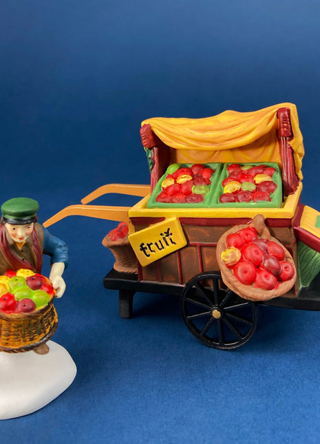 Christmas Village Accessories by Dept. 56. Porcelain, hand Painted Fruit Vendor. Chelsea Market Fruit Monger and Cart. Holiday Celebration.