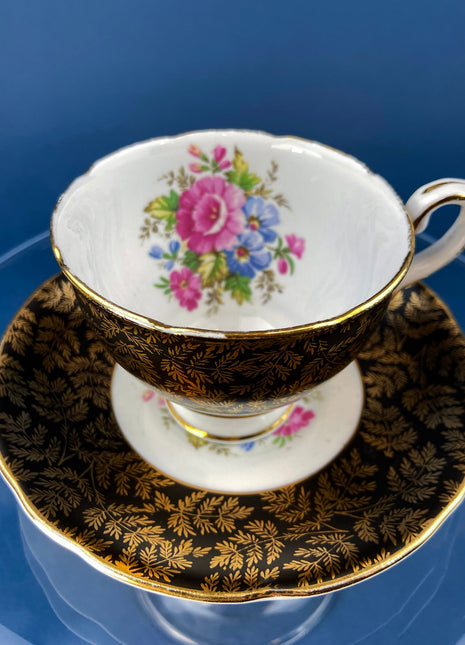 Royal Staford Cup and Saucer. Black with Gold Leaves. Hand Painted Flower Bouquet Inside of Cup and on the Plate.