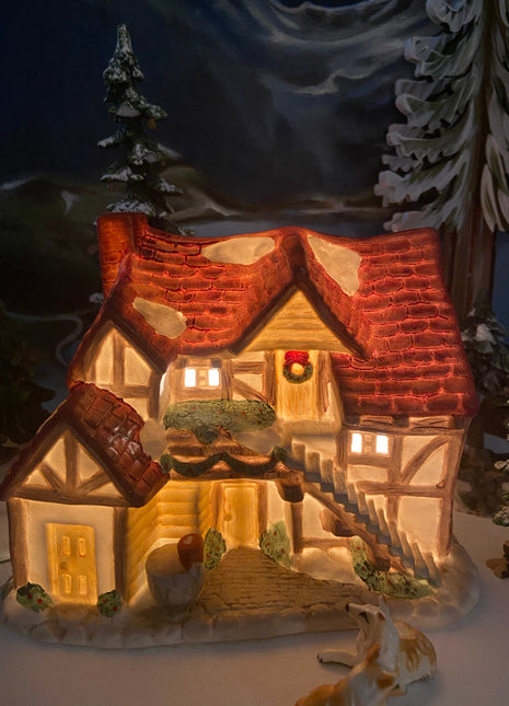 Christmas Village Farm House with Red Roof. Illuminated Building Holiday Decoration.