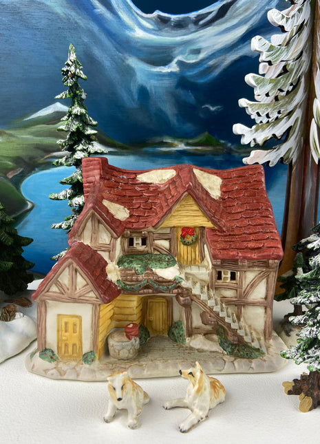 Christmas Village Farm House with Red Roof. Illuminated Building Holiday Decoration.