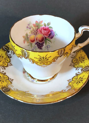 Antique Cup and Saucer by Paragon. White, Yellow, Gold, Pink. Made in England.