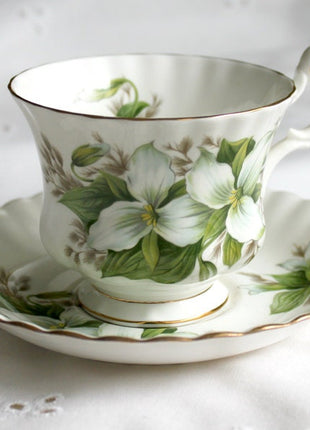 Teacup with Saucer by Royal Albert , England.  Hand Painted Trillium.  Beautiful Shape and Decor of Handle.